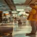 Traveler holding passport and boarding pass near a suitcase in an airport before an international trip